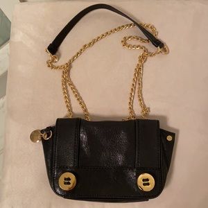 Milly black glazed leather mini flap bag with shoulder strap